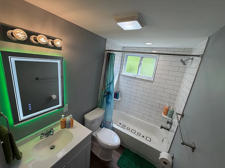 Bathroom with tile surround - mirror light can be changed to any color or white