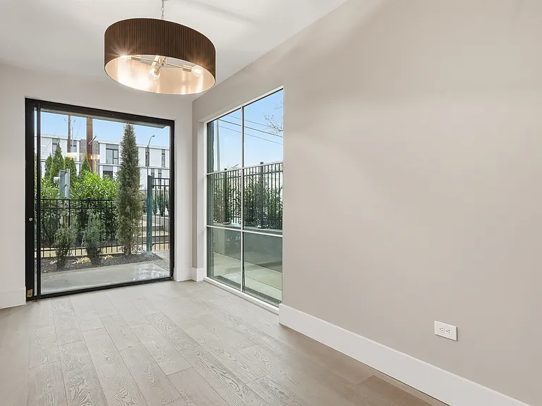Sunlit living space with modern finishes and expansive windows