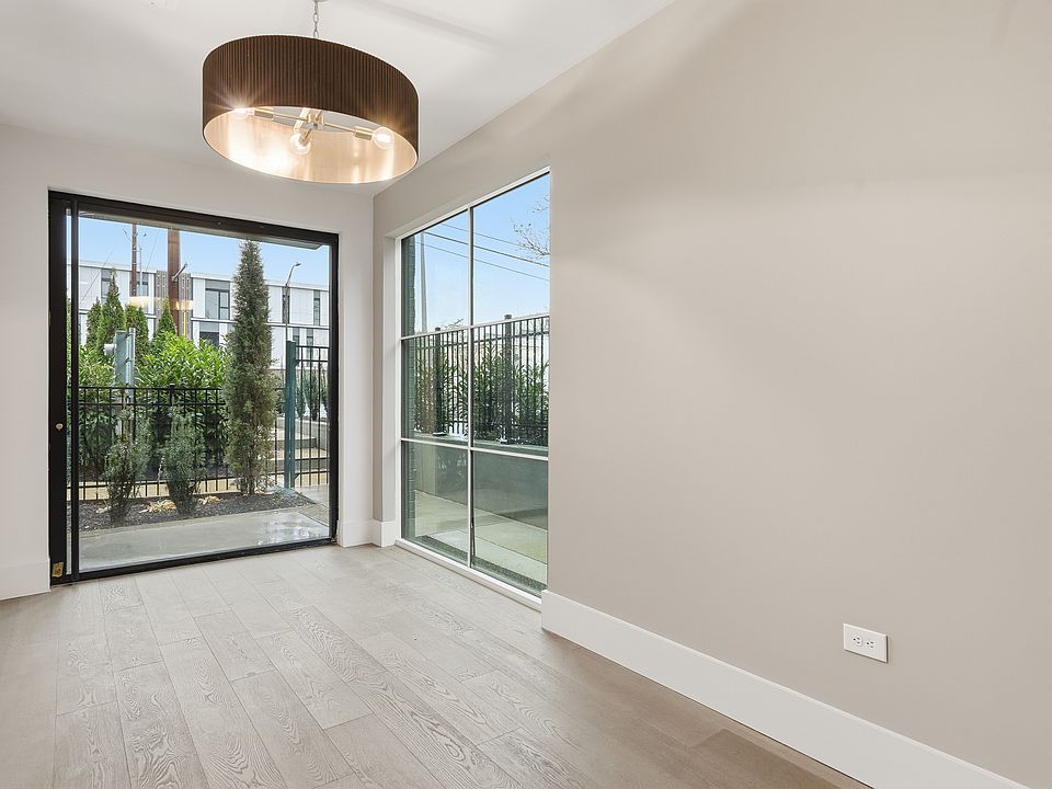 Sunlit living space with modern finishes and expansive windows