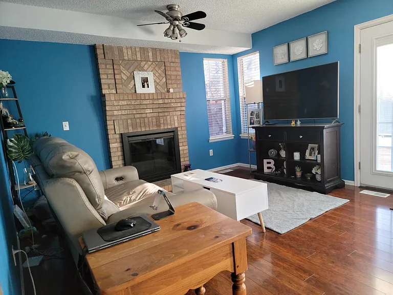 Family room with a gas fireplace. Look at the great sunsets over the cul-de-sac right from your couch!