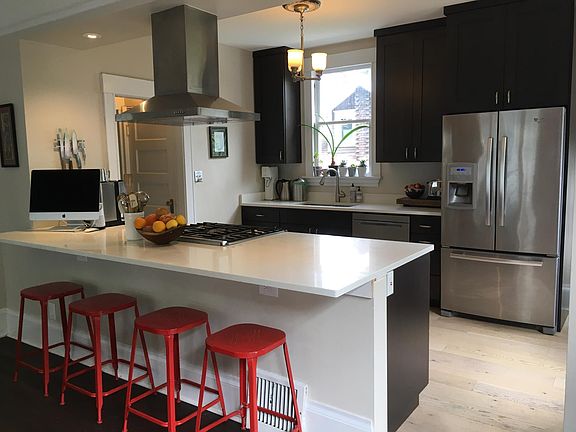 Open kitchen/dining with beautiful counter tops and bar
