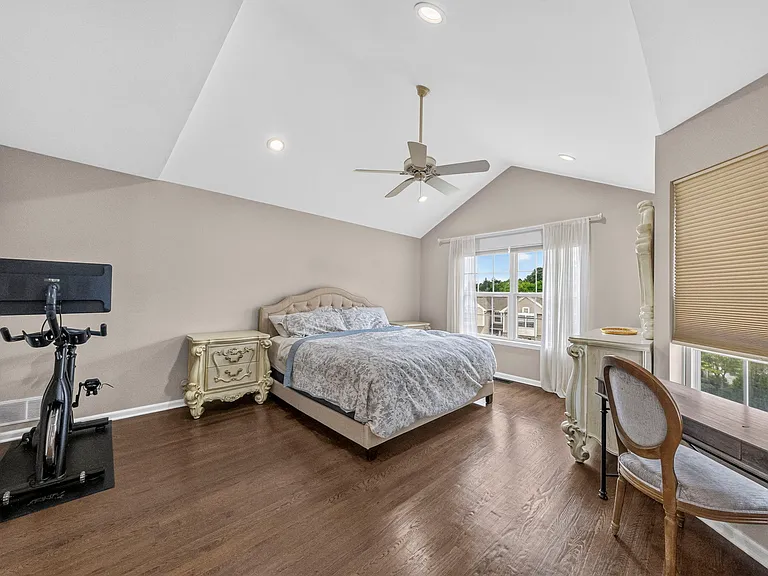 Spacious Master Bedroom with Vaulted Ceilings, Recessed Lighting, and Large Windows filling the Room with Natural Light.