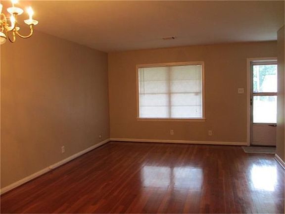 The living room is warmed with rich hardwood floors.