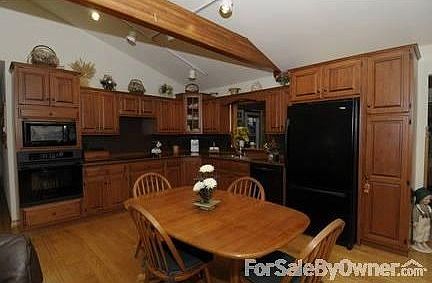 Open-Concept Kitchen : Oak plank flooring, wood beams, amish cabinets & upgraded appliances