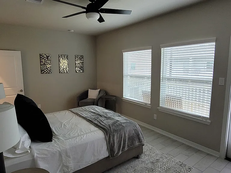 Downstairs bedroom with private balcony that overlooks the backyard
