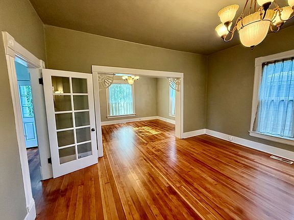 Living room & dining with a french door on the left leading to foyer/front door