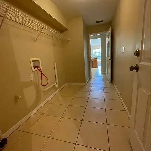 this is the laundry room, has washer and dryer hook up, leads to kitchen and garage