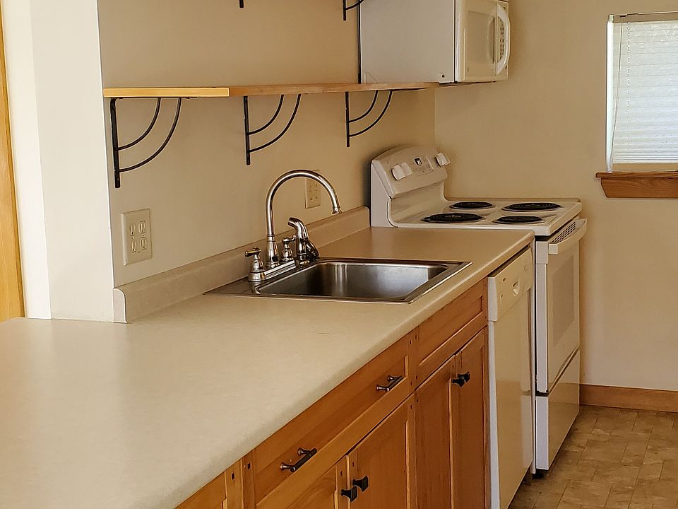 Galley-style kitchen with hickory cabinets and open shelving