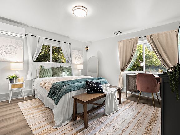 Work and unwind! This bedroom features a cozy workspace for productivity.