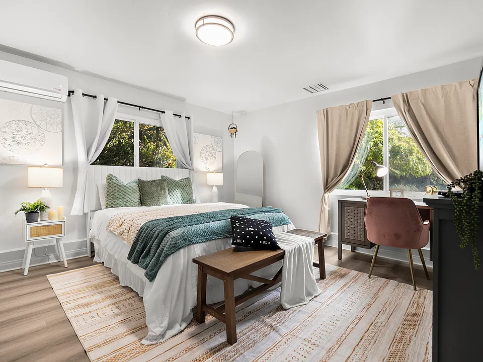 Work and unwind! This bedroom features a cozy workspace for productivity.