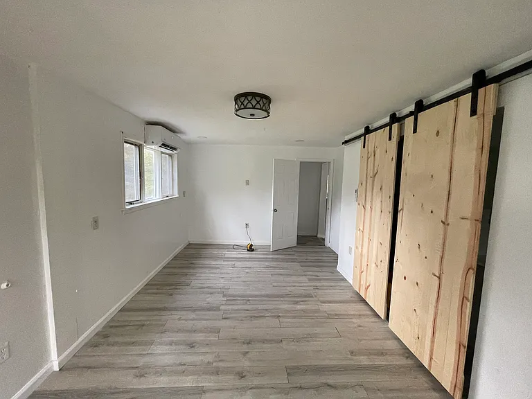 Other view of master bedroom to walk into hallway to lead into kitchen & dinning room master bedroom is located on first floor