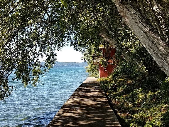 This is the established bulkhead with Boat house at the end.  At low tide the beach offers a plentiful array of oysters, clams, starfish, crabs and other marine life.  Adventure awaits the kayakers or boaters wanting to explore Hood Canal's waters. Tideland rights are included.