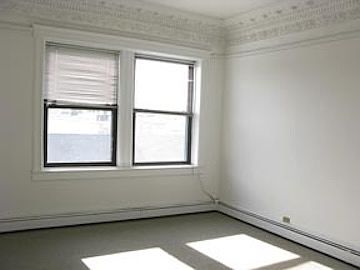 living room facing south. Sunlight all day, high ceiling, beautiful restored crown molding, large.