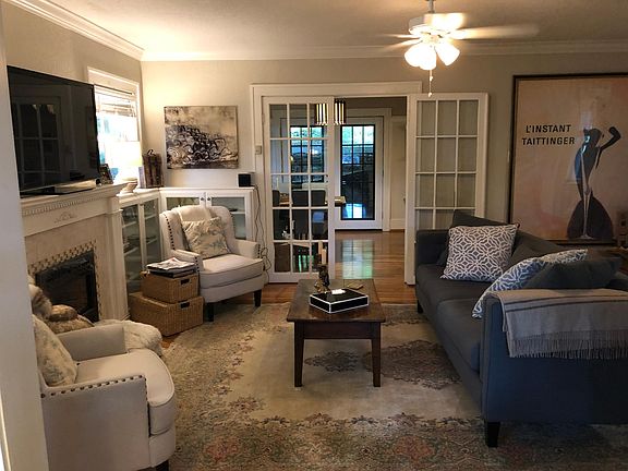 cozy living room with beautiful french doors leads to kitchen