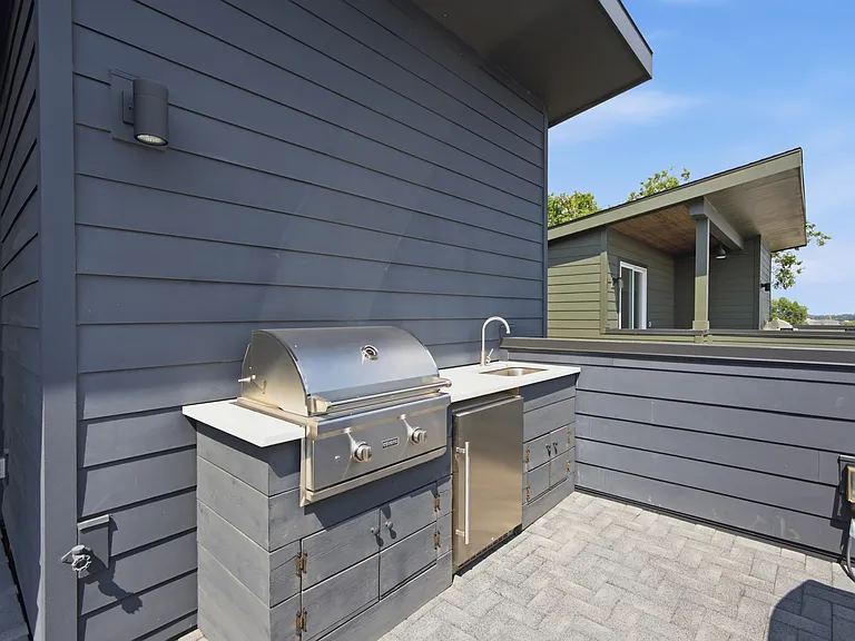 Gas grill and mini fridge on balcony