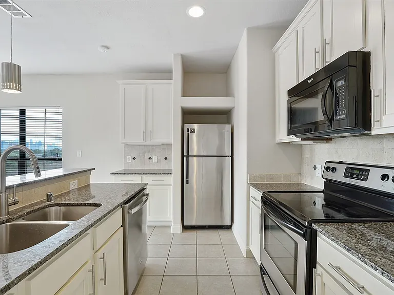 Granite counter with bright white cabinets!