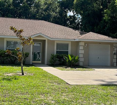 Front of house with parking pad.