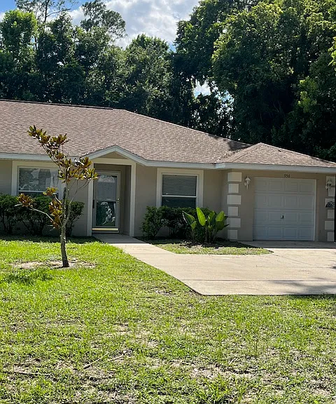 Front of house with parking pad.