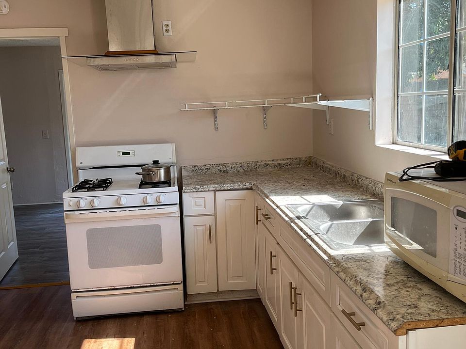 White Shaker cabinets . New vinyl Floor 
Kitchen