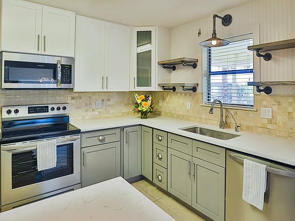 New modern kitchen with stainless appliances and quartz coun