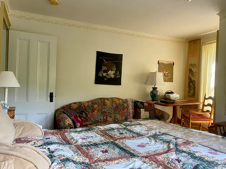This is the west facing bedroom which also serves as a living room with queen bed and large closet