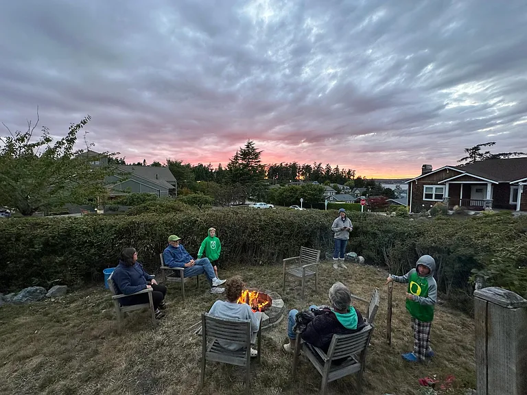 Enjoy sunsets at the front yard fire pit nestled behind the hedges!