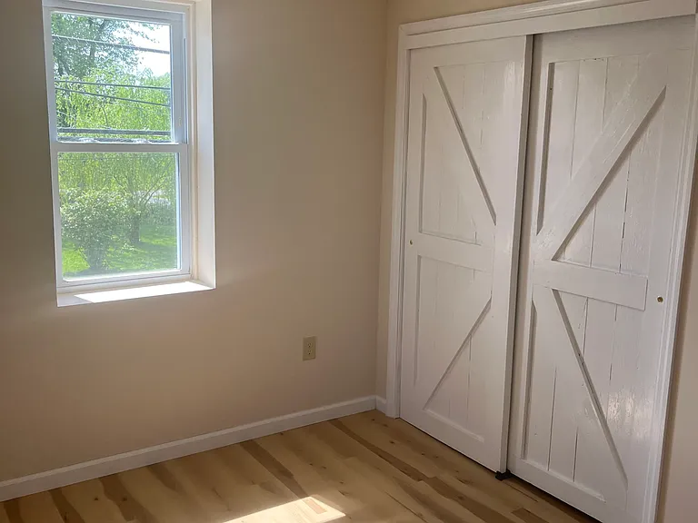 Bedroom, showing closet. Flooring is vinyl plank