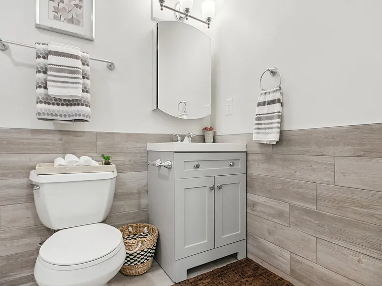 a white bathroom with a toilet and a sink