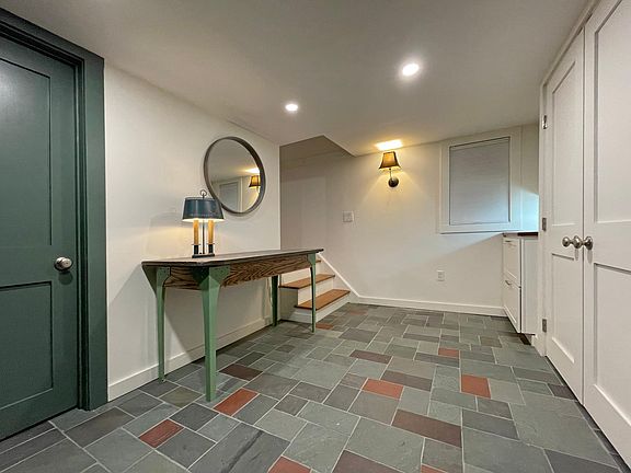 Brand new ground floor entry/mudroom with a large closet, counter and cabinets. It's shown finished here and ready to rent.