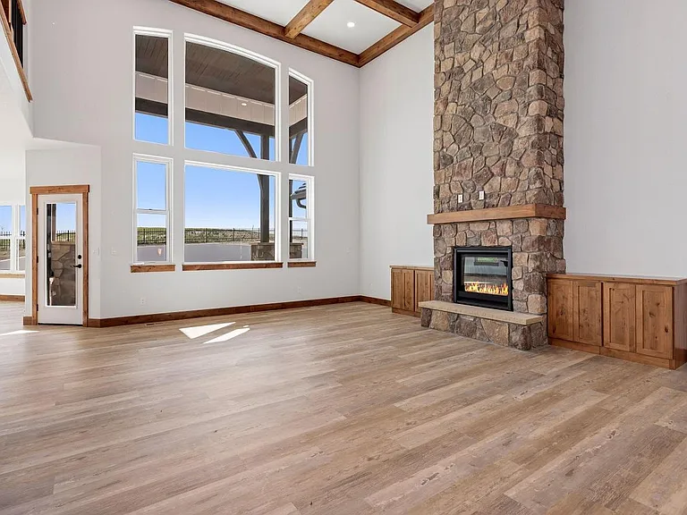 Living room with floor to ceiling 
Stone gas fireplace