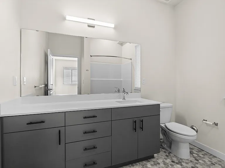 Start your day in a stylish bathroom with modern finishes, generous storage, and a spacious vanity area.