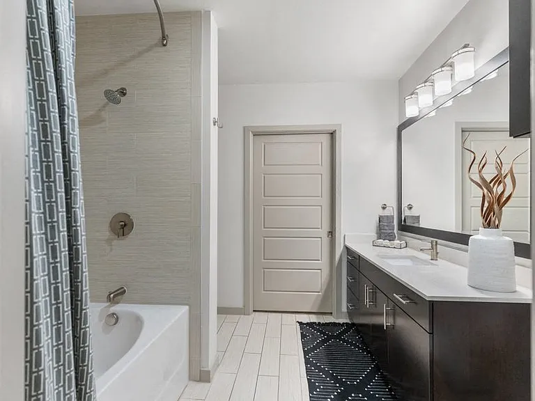 Modern bathroom features include upgraded lighting, fixtures and framed mirrors