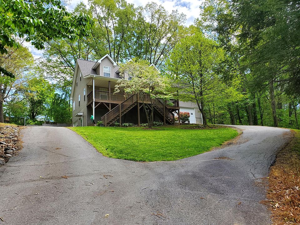 Wooded, private property in the heart of downtown Weaverville. Driveway forks to two separate garages on the left and right of home.