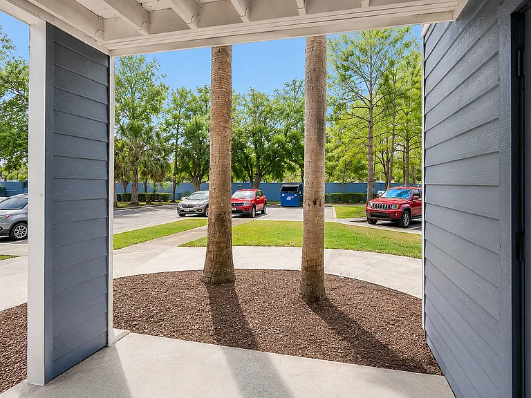 Cozy patio view showcasing lush greenery and vibrant surroundings with convenient parking access.
