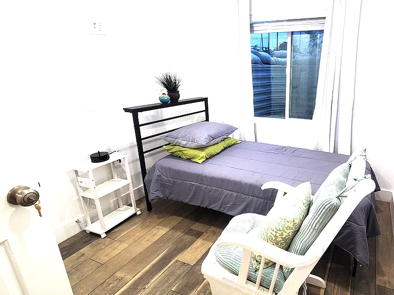 Bright and versatile second bedroom, now featuring blackout curtains for a perfect night's sleep. Combines great natural light during the day with total darkness when you need it. (Furniture not included).