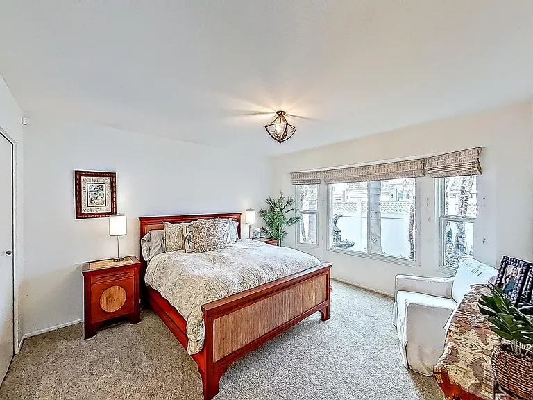 Primary King Bedroom Downstairs with bathroom, electric fireplace and small walk in closet.