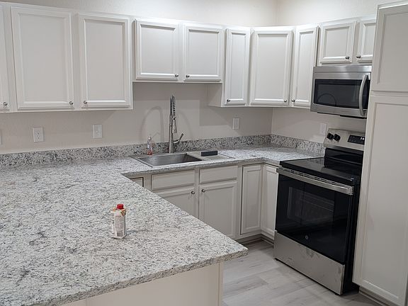 brand new kitchen for the chef in the house. new counter tops, deep farm sink, stainless steel appliances, breakfast bar