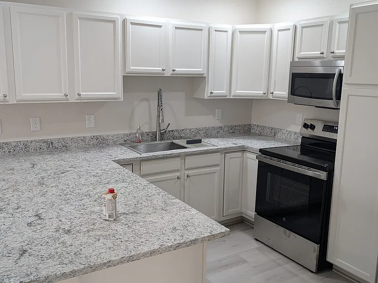brand new kitchen for the chef in the house. new counter tops, deep farm sink, stainless steel appliances, breakfast bar