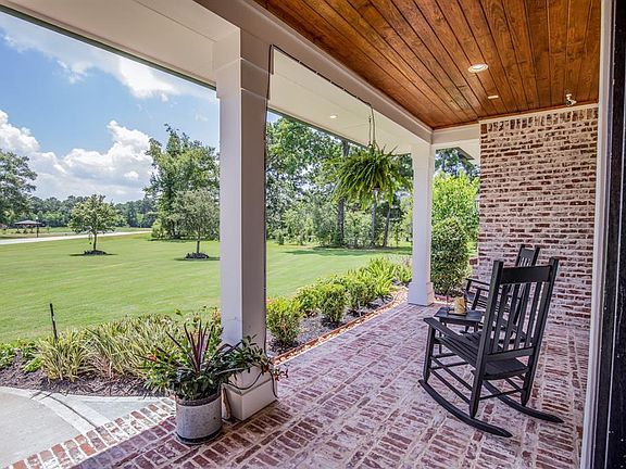 Peaceful view from the front porch to the 11 acre lake make for lazy-day afternoon conversations. Watering system for potted and hanging plants.
