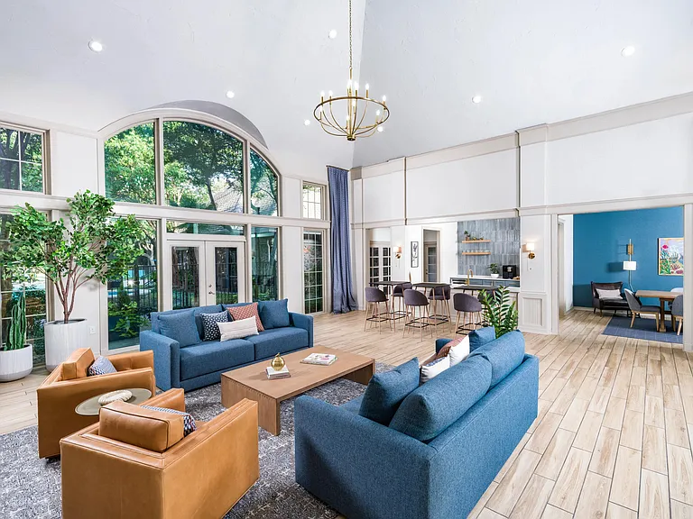 A stylish, sunlit gathering space with seamless access to the club kitchen, dining room, and outdoor views.