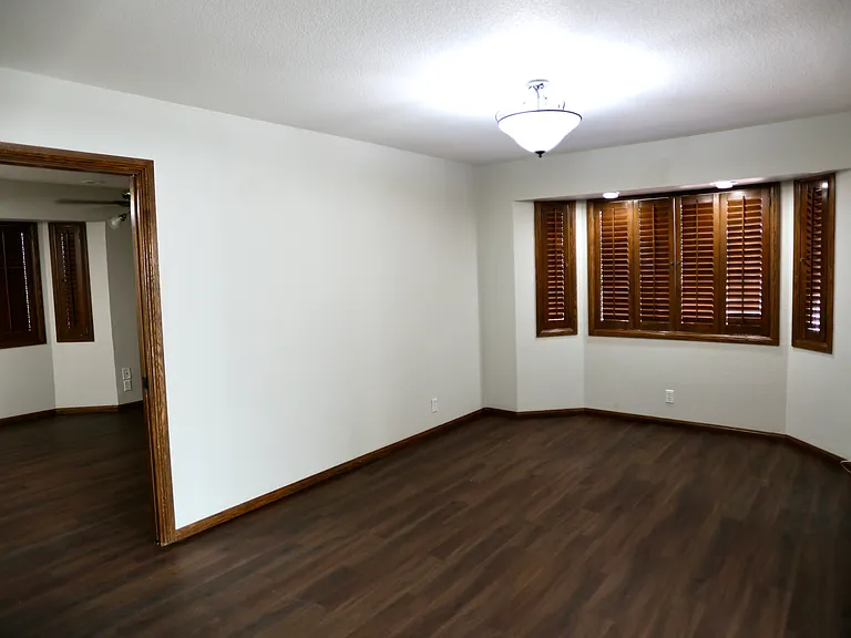 Front living area. Wood shutters on nearly all windows