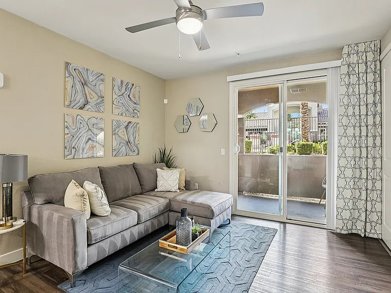 View of Living Room and Sliding Glass Door Leading to Shaded Patio