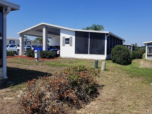side yard with screened lanai in back