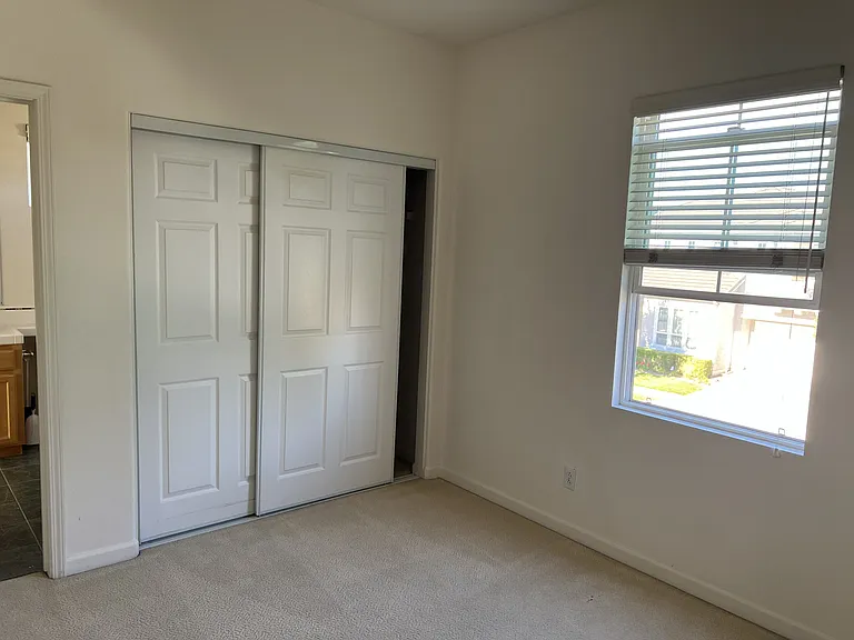 Bedroom 2 (facing east) connected to Jack & Jill bathroom. Large sliding door closet.