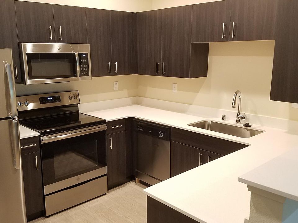 Renovated kitchen with quartz counter tops, stainless steel appliances and sink, designer cabinets and hardwood style floor.