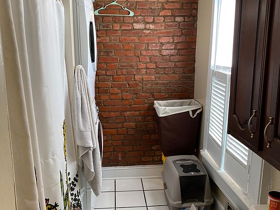 Stack washer and dryer hookups in the left corner. Washer and dryer in image belongs to current tenant.