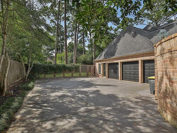 Fabulous 3-car garage located to the left side of the home is accessed through a private automatic gate. Garage area provides an abundance of parking and offers a wall of built-in cabinets for all your storage needs.