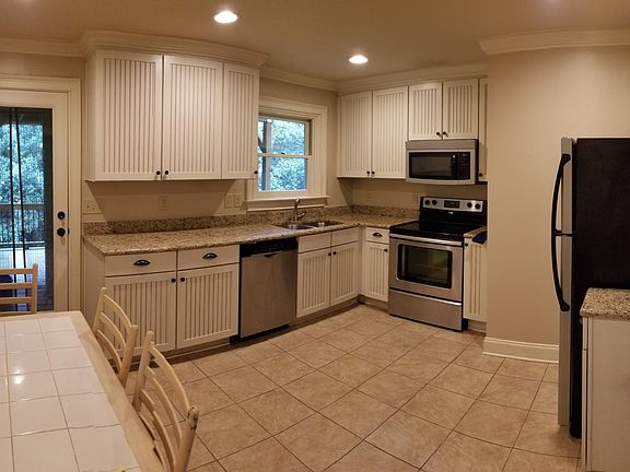 Kitchen with eat-in dining area. Door leads to deck.