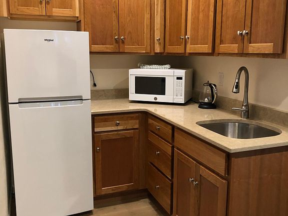 Cherry wood kitchen cabinets with quiet, slow close hinges.