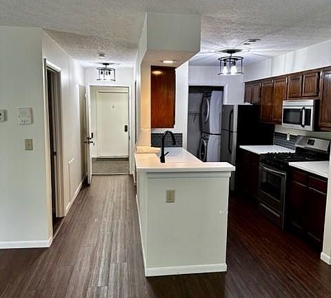 kitchen on the right- hallway to front door and primary bedroom door on left
